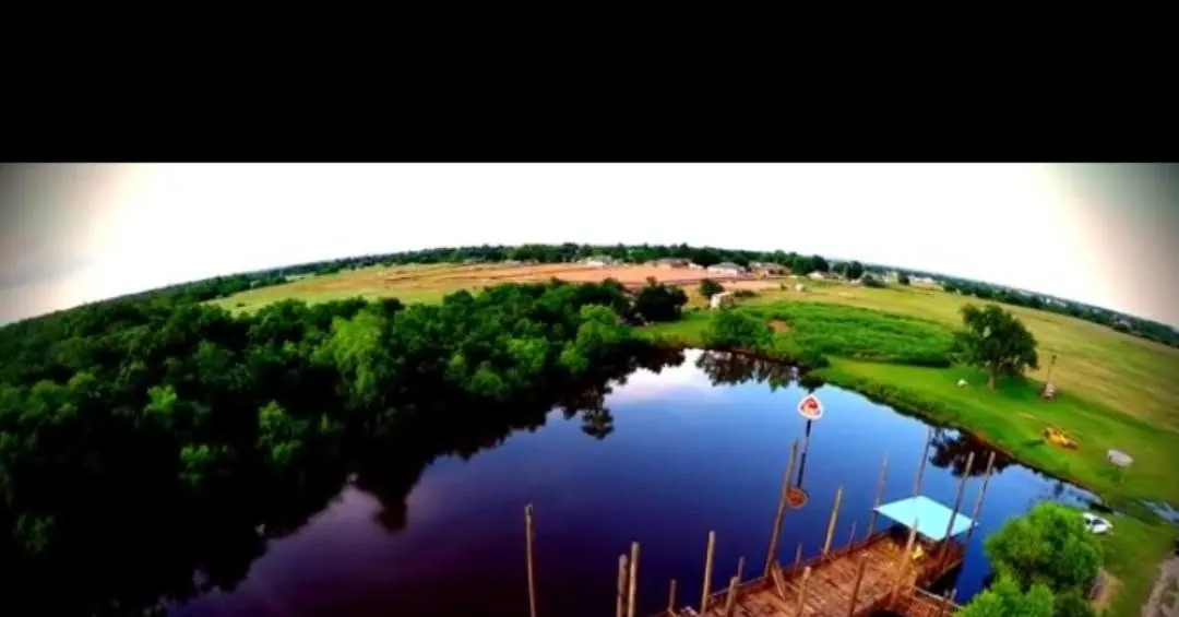 Aerial view of the pond and riverfront deck at Muscle Car Ranch in Chickasha
