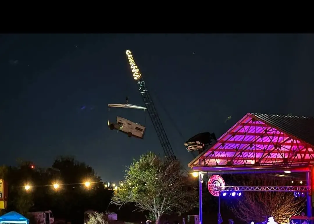 Night concert stage and crane stunt during TwisterFest at Muscle Car Ranch in Chickasha Oklahoma
