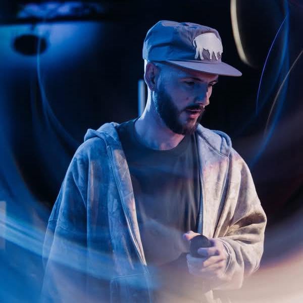 Colt Liles performing under blue stage lighting