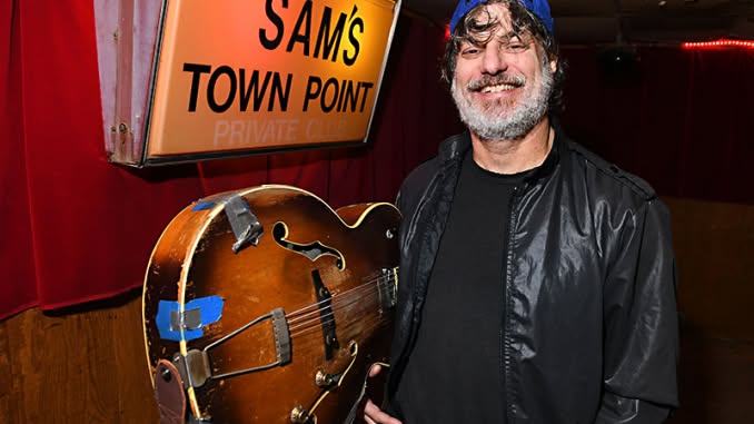 Ramsay Midwood holding his guitar