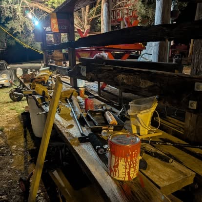 Construction tools and paint on a workbench during TwisterFest stage preparation at Muscle Car Ranch